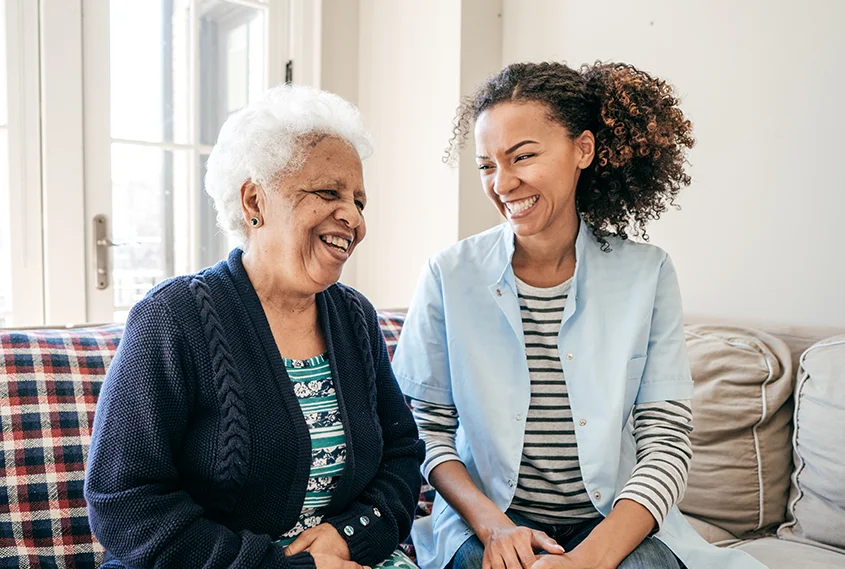 Older lady and younger lady laughing together