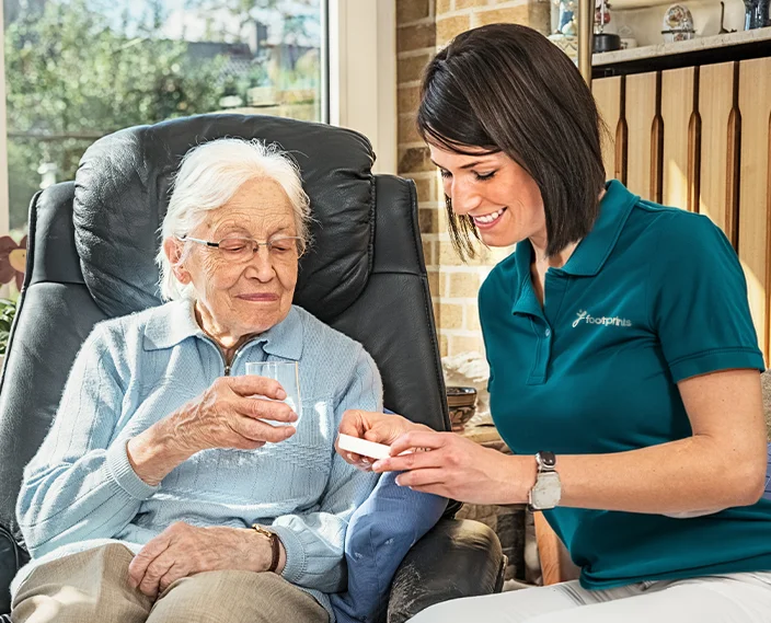 Footprints worker providing care to older woman