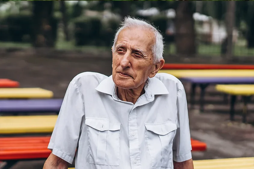 Older man sitting on park bench