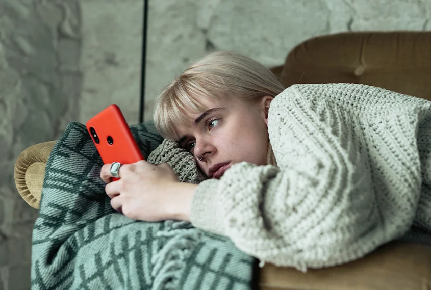 Person using mobile phone to refer on lounge