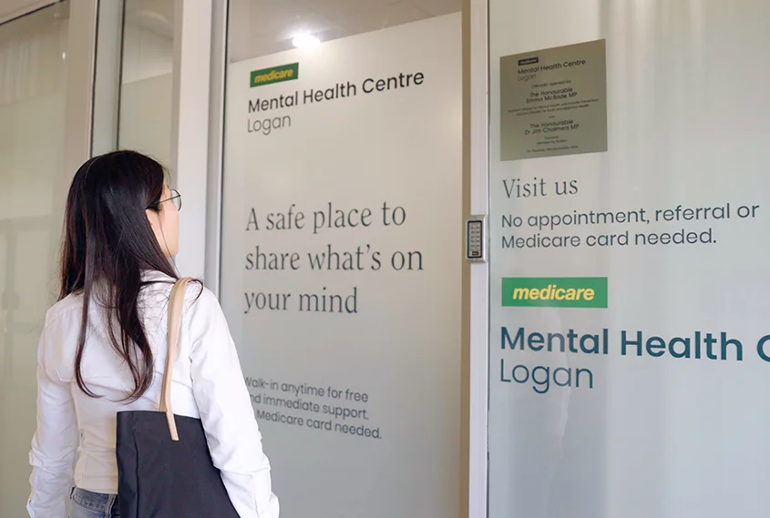 woman at the doors of a Medicare health clinic
