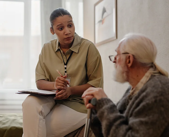 Older man chatting to support worker