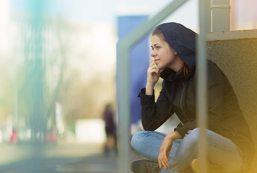Woman sitting outside thinking
