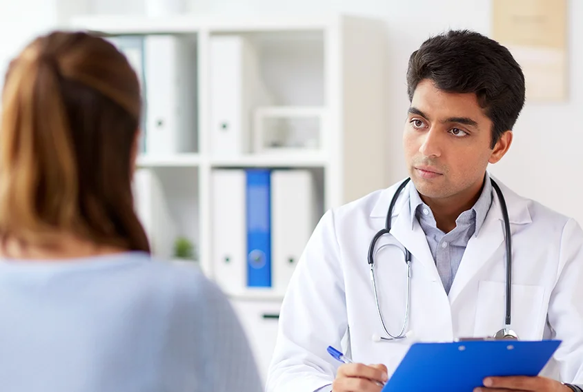 Woman talking to doctor