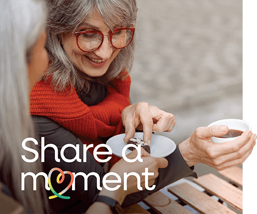 Lady sharing a moment of kindness with a cup of tea and a biscuit